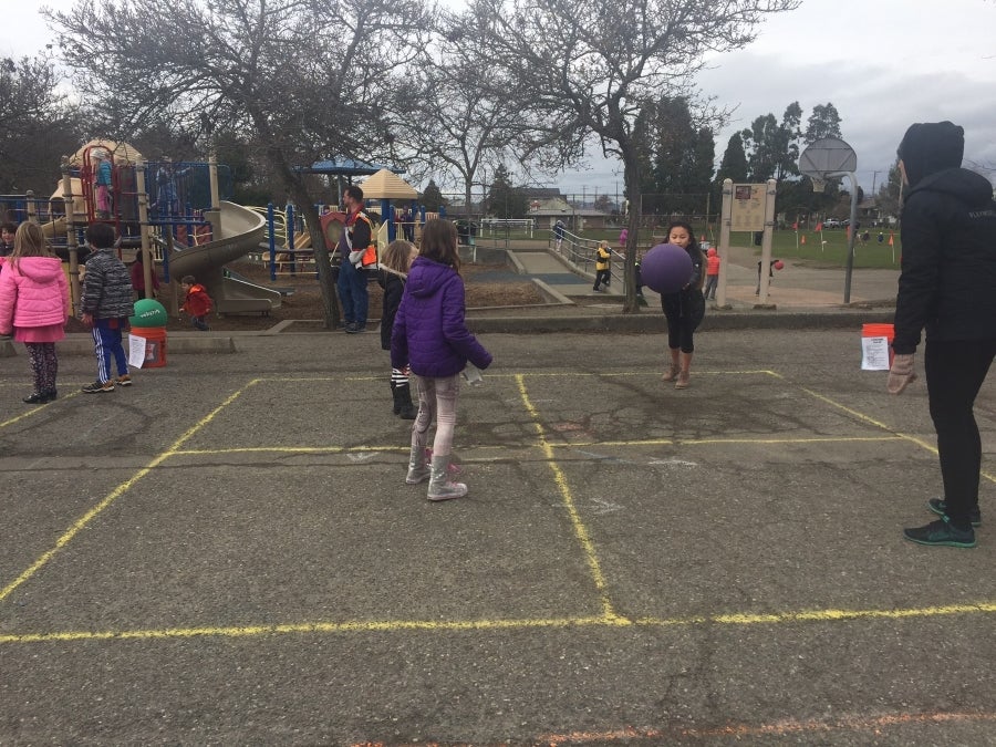 students playing four square at recess